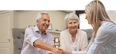 Man shaking woman's hands