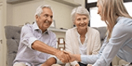 Elderly couple shaking hands with the navigator