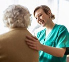 nurse putting reassuring hand on woman's back