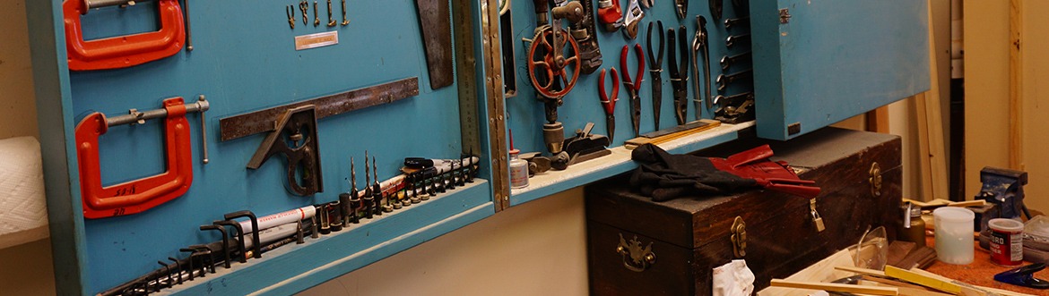 tools hanging on the wall in a workshop