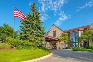 Exterior or building with manicured lawn and American flag