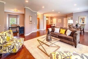 Living room with brown couch and yellow patterned arm chairs