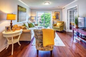 Living room with couch and chairs and porch in the back