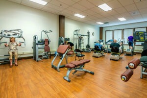 Gym with residents using different kinds of weight machines