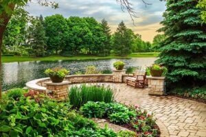 Sitting area on pavers next to pond