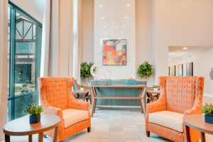 Waiting area with two orange arm chairs