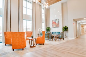 Sitting area in lobby with orange and green chairs
