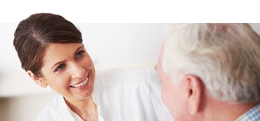 Woman smiling at older man